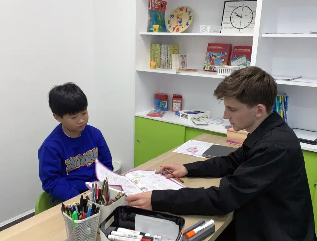 Male Tutor Teaching Young Boy