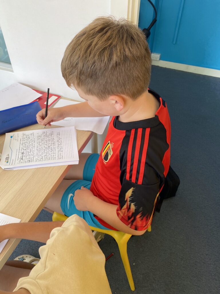 Young Boy Writing in Tutoring Class