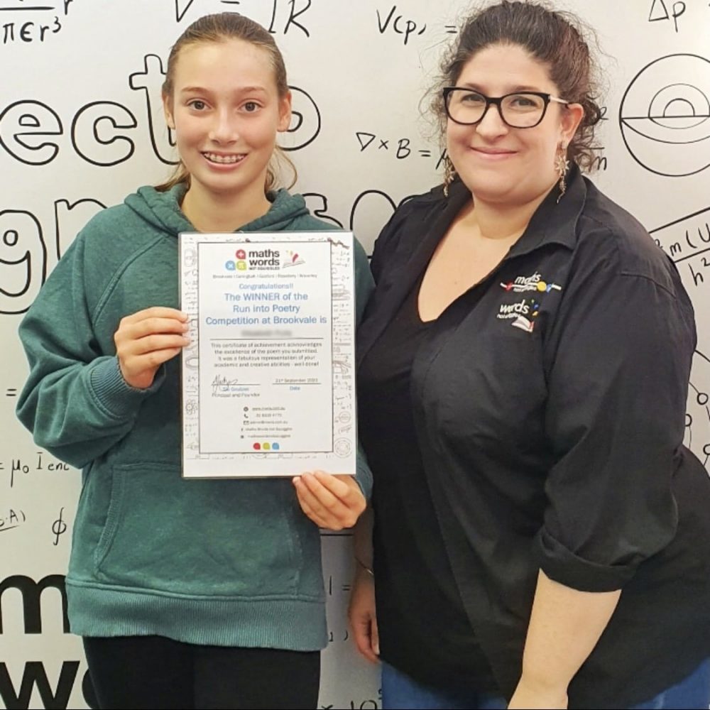 Smiling tutor celebrating success with a student and award certificate