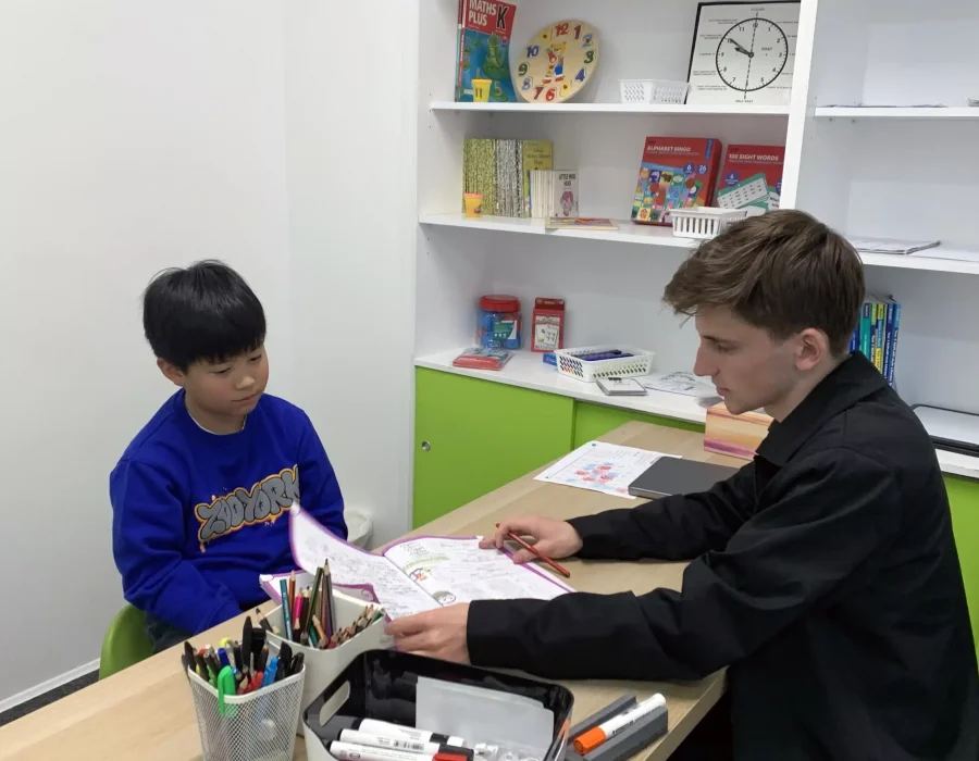 Male Tutor Teaching Young Boy